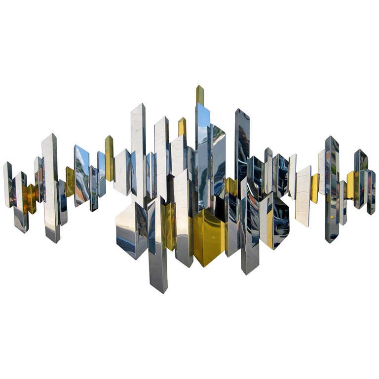 A sparkling chrome and brass cityscape wall sculpture by C. Jere. C.1970's.