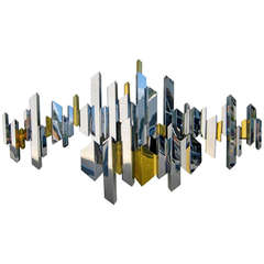 A sparkling chrome and brass cityscape wall sculpture by C. Jere. C.1970's.