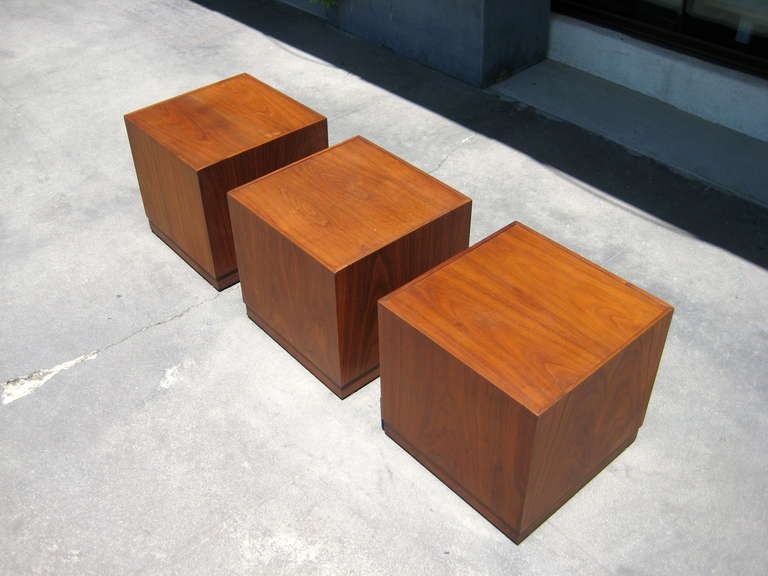 Three walnut cube form side/coffee tables.