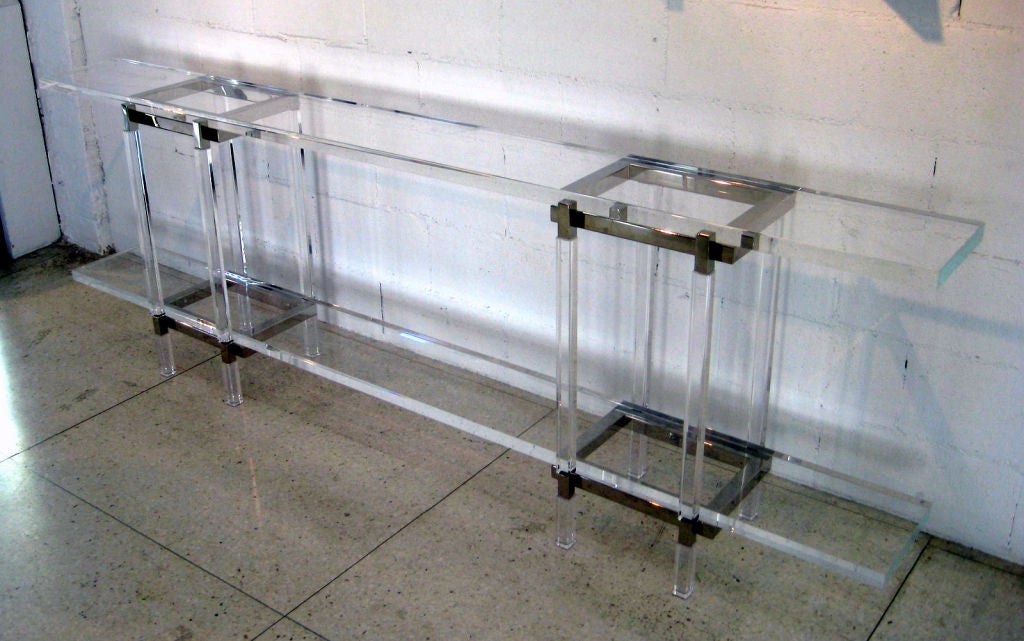 A two-tier acrylic and nickel-plated steel console table from the Metric Line designed by Lucite legend Charles Hollis Jones in the early 1970s. This shallow console table has planks of acrylic that are suspended between a pair of acrylic and