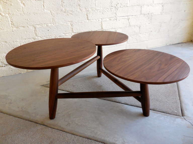 A fun and engaging three level walnut Mid Century coffee table.  C. 1960's.  The three circular 