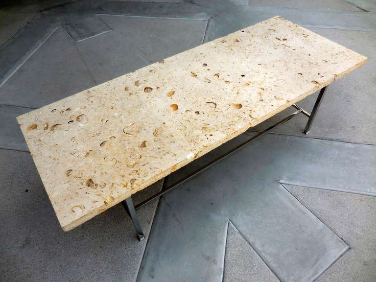 A 1950's shell stone and chromed steel coffee table by Harvey Probber.
The original stone top is made of a super select fossilized shell stone with large open sea shell fossils scattered across the surface. The top is amazing and this quality of
