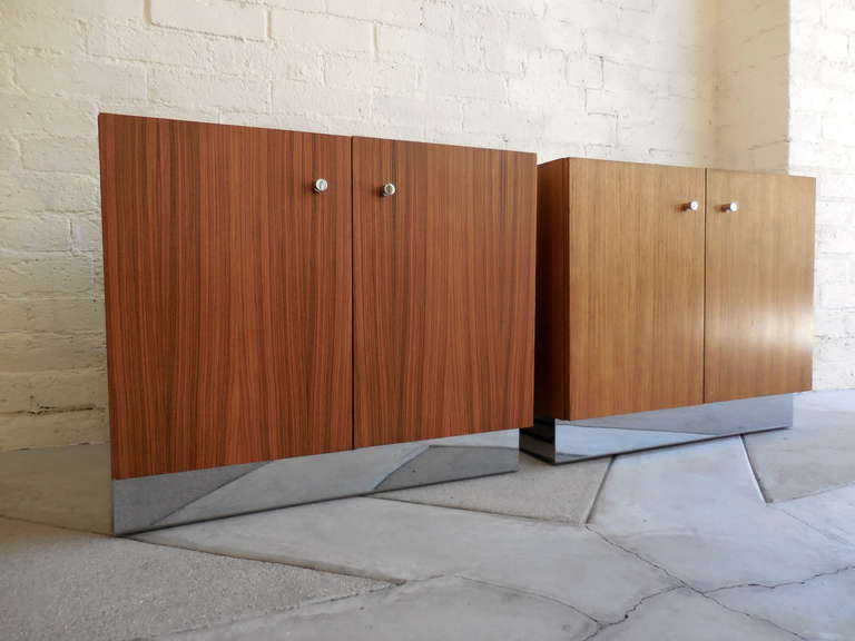 A pair of georgeous zebrawood bedside cabinets designed by Milo Baughman for Thayer Coggin in the 1970's.  These cabinets are raised on chrome plated plinth bases and the door hardware is also chrome plated.  There is one adjustable shelf in each of