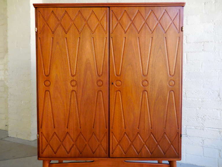 A graphically patterned Swedish mahogany cabinet on legs.  C. 1960's In Excellent Condition In Palm Springs, CA