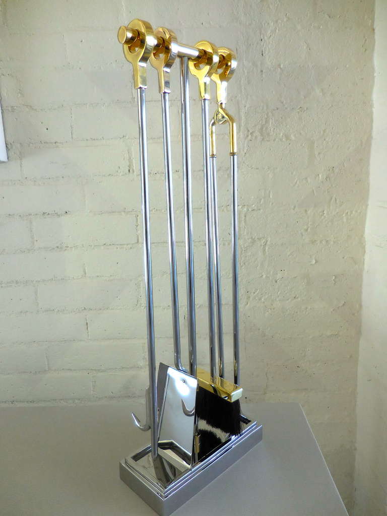 A rare set of polished steel and brass fire tools by Karl Springer in the 1970's.
This set is composed of 4 polished steel and brass tools and a 