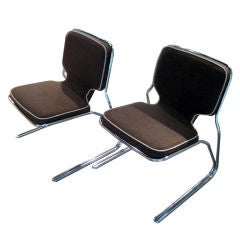 A pair of cantilevered chairs in the style of Jerry Johnson