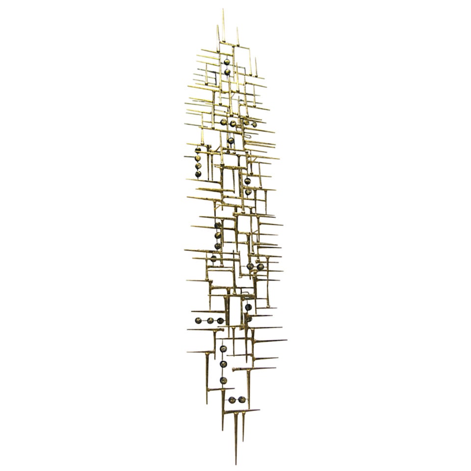 A  76" long gilded steel wall sculpture by American artist Del Williams