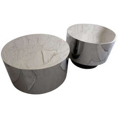 A gleaming pair of polished steel drum tables on leather clad recessed bases