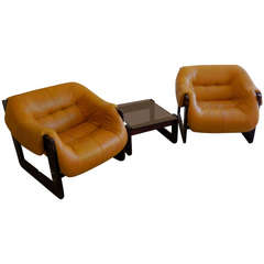 A pair of 1970's leather and rosewood Percival Lafer club chairs with side table