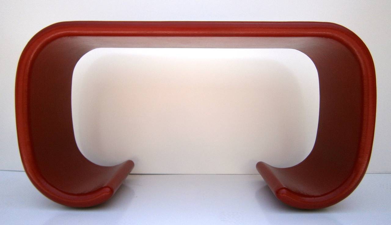 A superb lacquered linen wrapped Asian-form console table in the style of Karl Springer.  Circa 1970s.  The table has been newly restored with a dynamic fire engine red lacquered finish.  It is finished on all sides and would be perfect in an