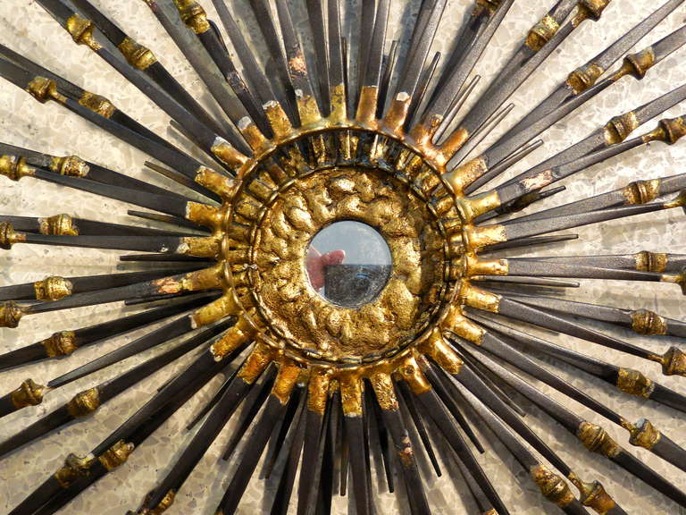 A dynamic radiant wall sculpture with gilded details and a mirrored center by American artist Del Williams.
