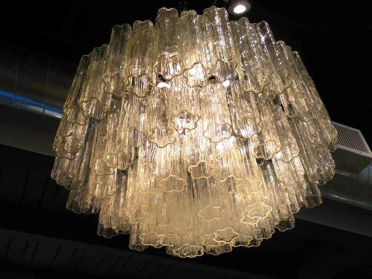 A very large multi-tiered Murano glass chandelier made by Venini in the 1960's.
There are 7 tiers of mold-blown glass 
