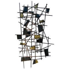 A vintage 1960's metal wall sculpture with gilded accents