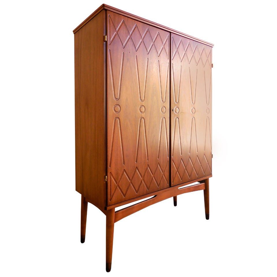 A graphically patterned Swedish mahogany cabinet on legs.  C. 1960's