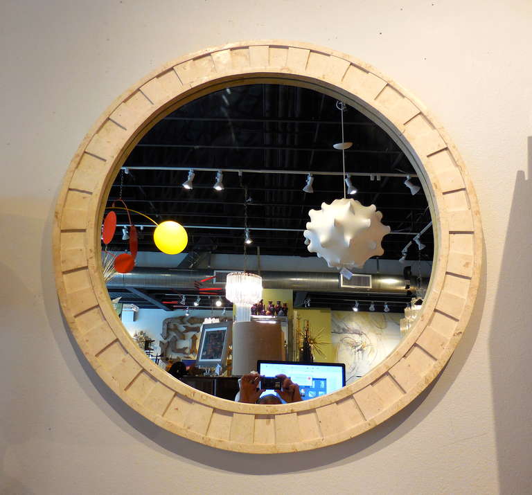 A marble framed circular mirror from the 1980's.  The framed section is 4