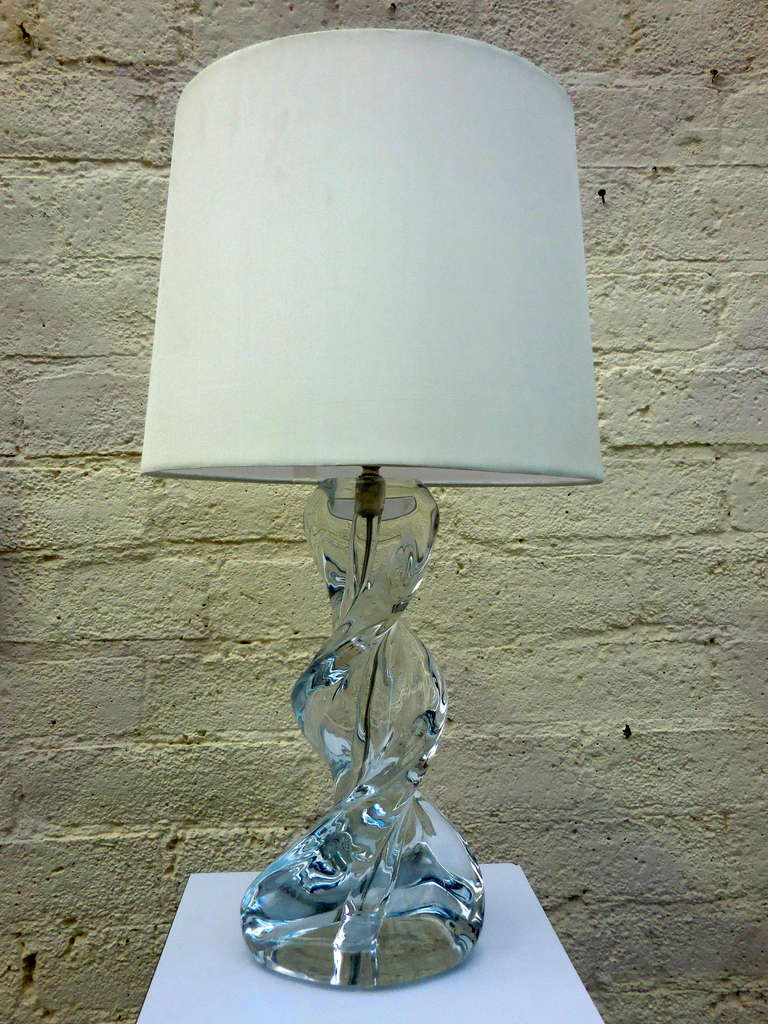 A French swirled crystal lamp from the 1950's. There is an acid etched signature of Sevres on the bottom of the lamp.  This Art Deco inspired lamp base is made from high quality lead crystal and would be beautiful as a desk lamp or in a ladies