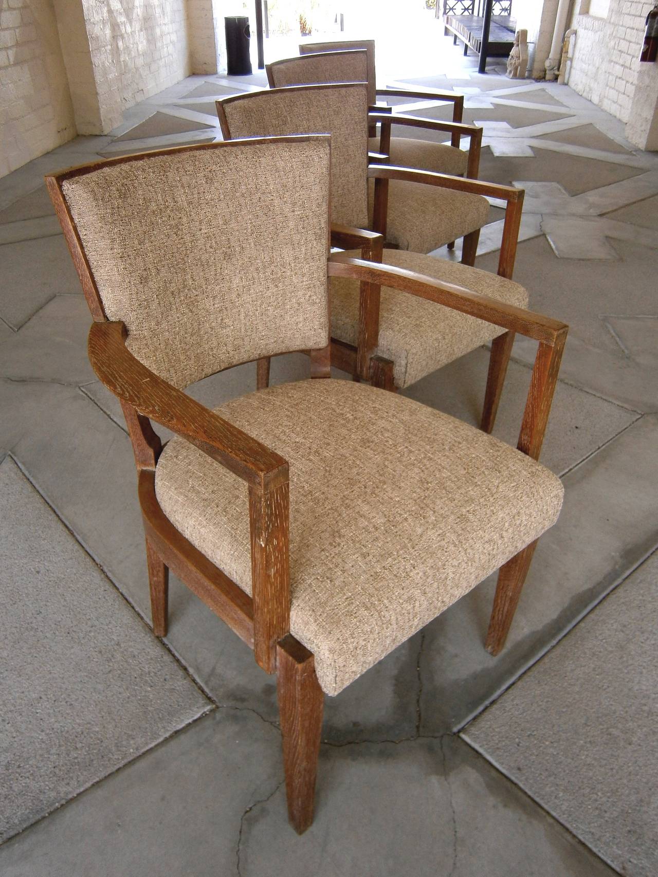 A chic set of 4 French Art Modern period cerused oak armchairs from the 1940s. This set exudes quality and sophistication without any over-adornment to the minimalist design. The shield-shaped back of the chair has a low-rise, with the seat being
