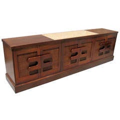 A large 1970's walnut credenza in the style of Arthur Elrod.