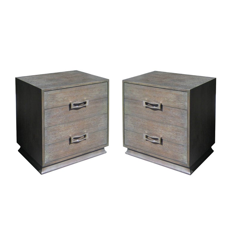 A pair of cerused nightstands with nickle "buckle" pulls