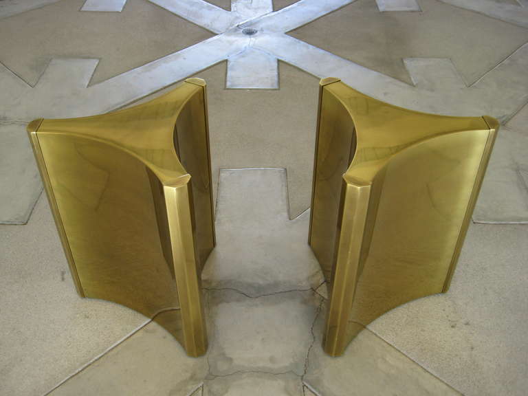 A pair of highly sought after "trilobi" (three lobed) Mastercraft brass plated steel pedestal dining table bases c.1970's. These are in excellent original condition. There is no top available with this table. Traditionally, a rectangular