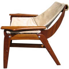 A walnut sling chair designed by Jerry Johnson in 1964