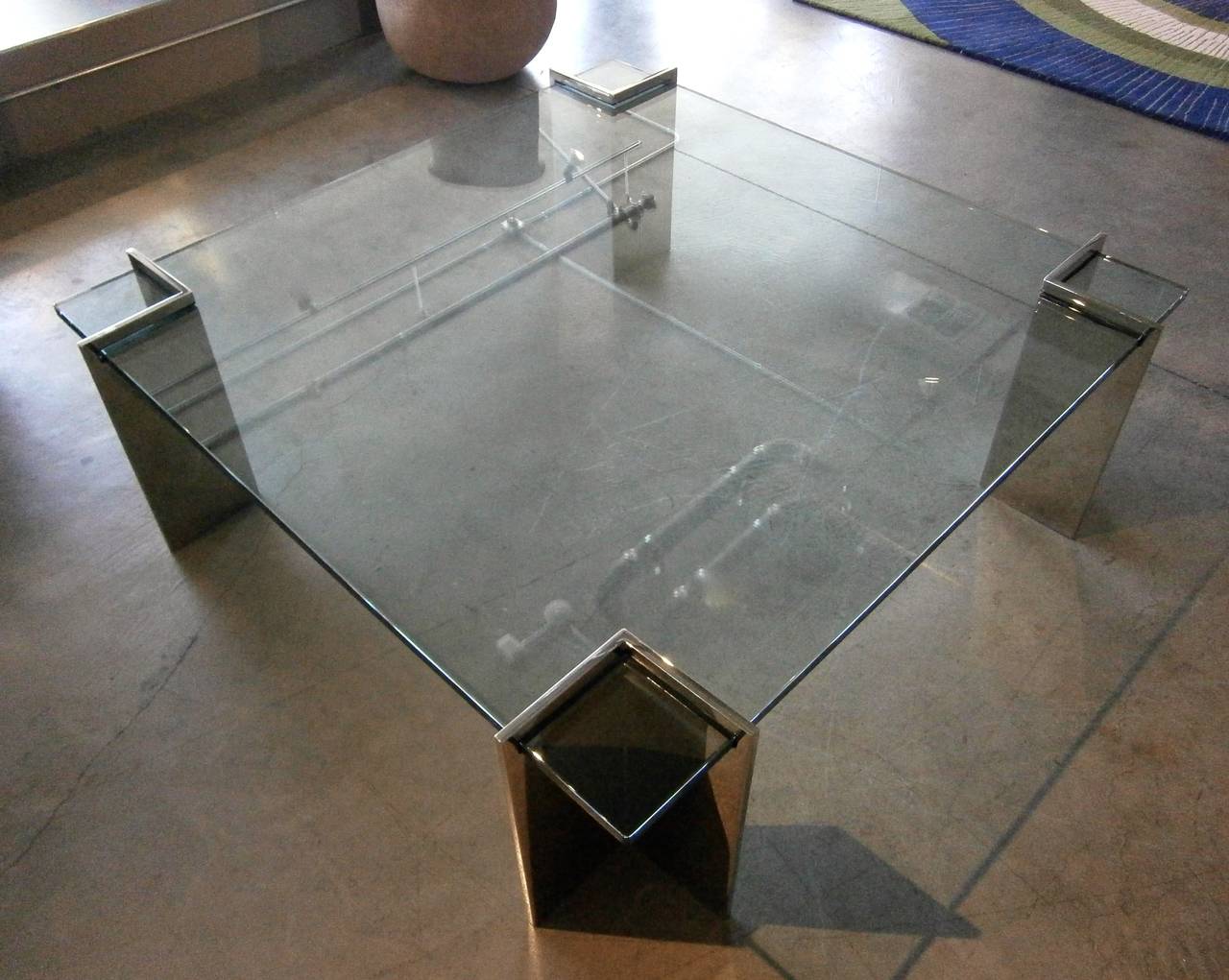 A sensational glass and polished steel square coffee table designed by Leon Rosen for Pace Collection. C. 1970s. The 3/4