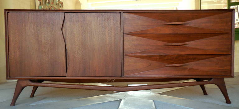 A superbly crafted walnut 1950's diamond fronted cabinet by American designer Albert Parvin. The right side has three sculptural faced drawers on durable glides. The drawer fronts are deeply crafted diamond forms with complementary diamond handles