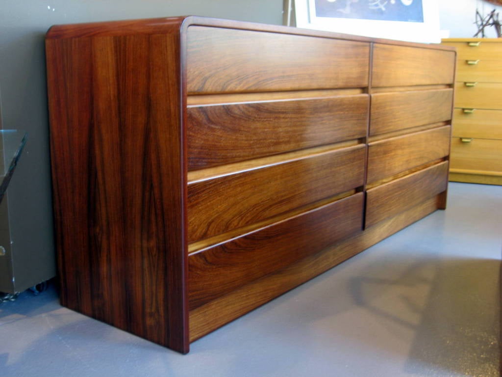 Rosewood A 1970's bookmatched rosewood 8 drawer chest with waterfall edge
