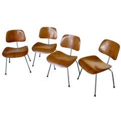 A set of four early Charles and Ray Eames DCM chairs C.1950's