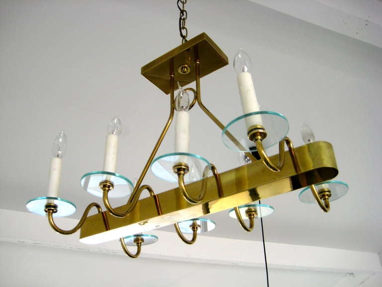 A solid brass elongated ceiling fixture / chandelier with glass bobeche in the style of Fontana Arte.  The fixture can be mounted to the ceiling or hung on chain.  It has been newly polished and rewired.