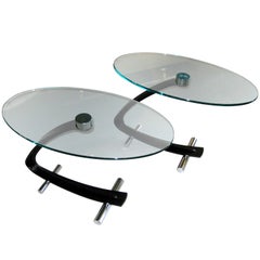 A pair of  black steel and glass  "boomerang" side tables