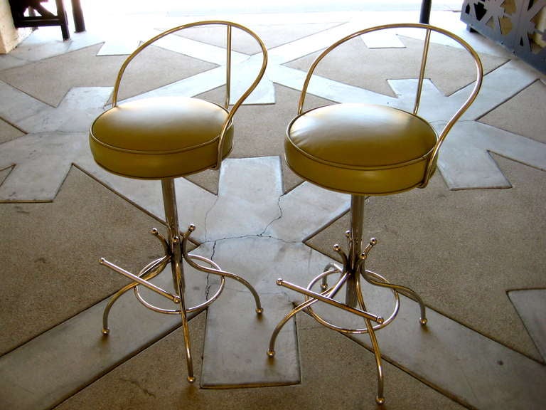 A pair of curvacious swiveling bar stools, manufactured by the Los Angeles firm Hudson-Rissman.  C. 1965. These bar stools are distinguished by the newly nickel plated steel body and new high quality hand selected leather upholstery.