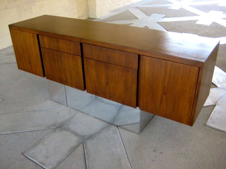 A fine quality and desirable walnut credenza raised on a 10
