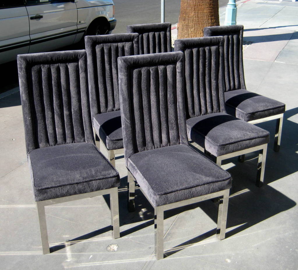 A set of newly upholstered channel back dining chairs made by Hill Manufacturing Company in the manner of a tall back dining chairs designed by Charles Hollis Jones. These chairs rest on glamorous nickel-plated steel bases. The upholstery is an
