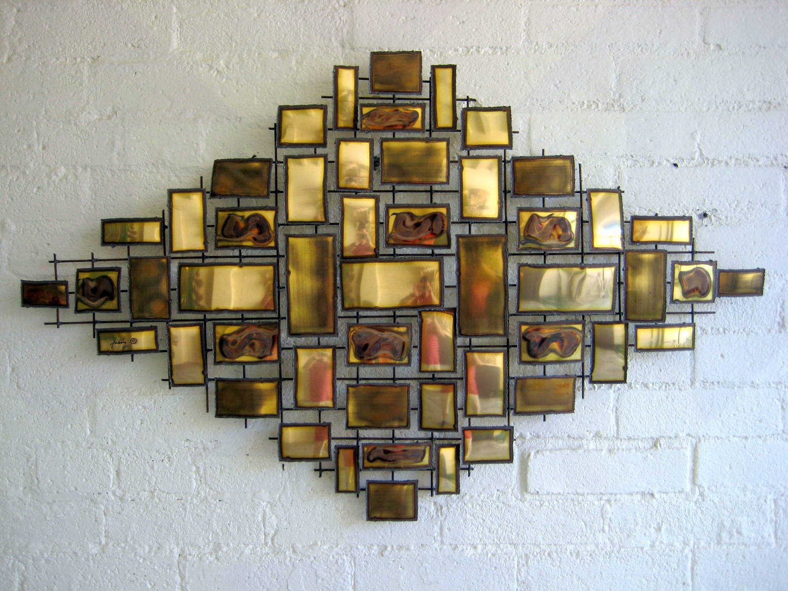 A polished and burnished brass metal wall sculpture by "Jason" c. 1970's
