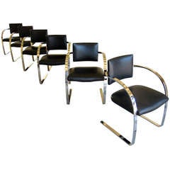 A set of six steel and leather dining chairs by Mark Mascheroni for Brueton