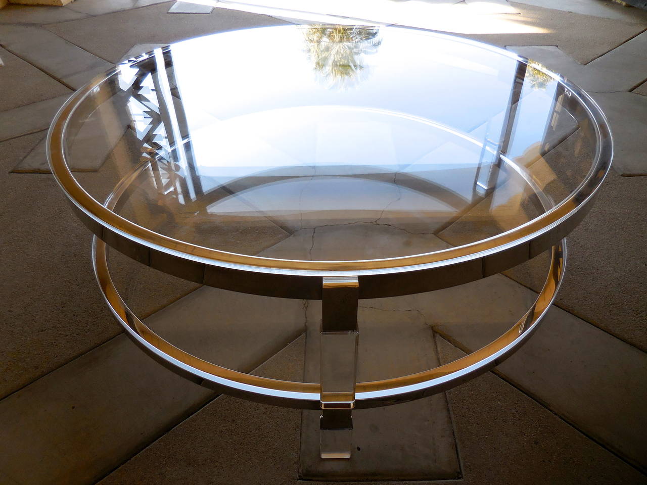 An amazing two-tier circular cocktail table designed by Charles Hollis Jones for his Metric Line. Three acrylic posts attach to the circular nickel plated metal framework that holds thick Lucite shelves. Top shelf fits snugly into the framework with