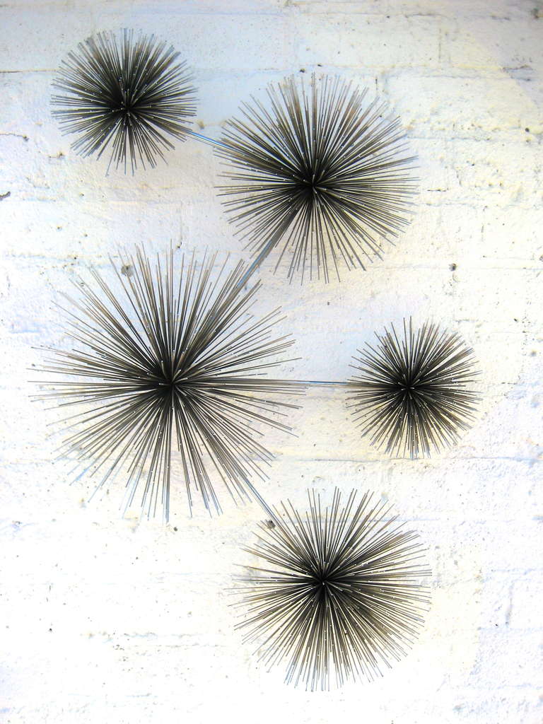 A chrome pom pom/sea urchin wall sculpture by Curtis Jere c. 1970's.