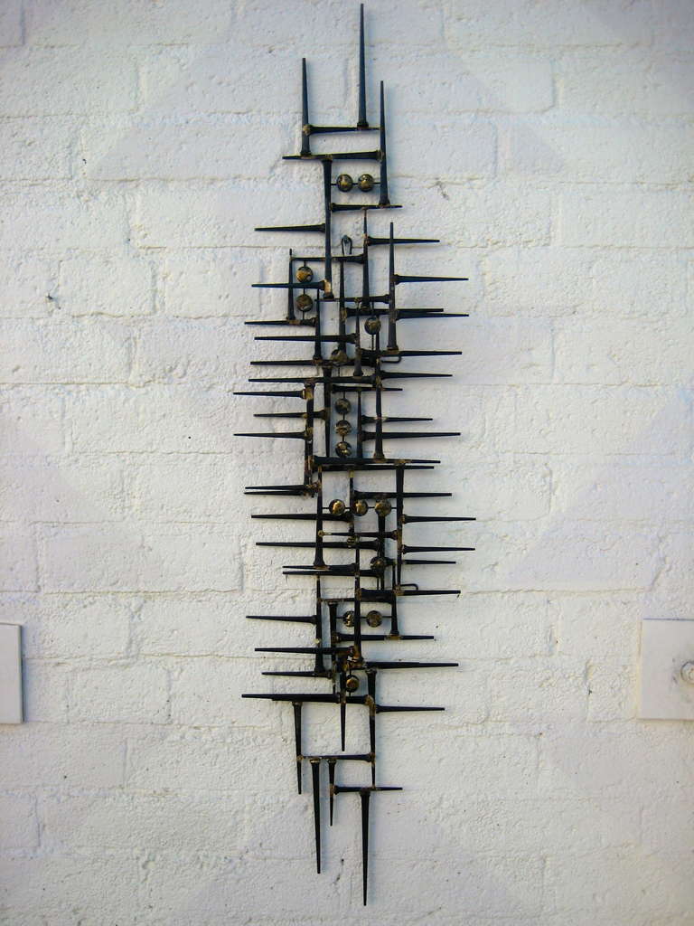 A Welded steel modernist wall mounted sculpture by American artist Del Williams. Using traditional welding techniques, Del Williams creates wonderful wall sculptures that evoke the intricate and sophisticated stylings and patterns of 1960's American