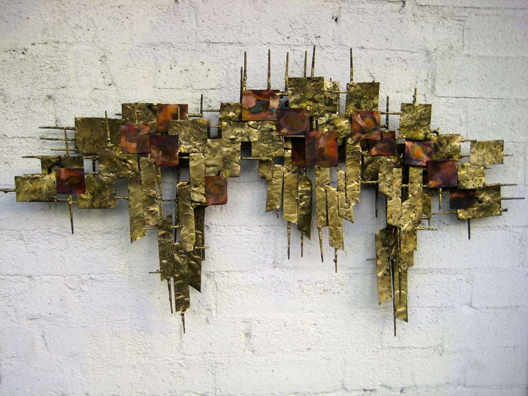 A 1960's gilded steel and copper wall sculpture attributable to Peter Pepper Products. I have this sculpture shown in two positions as it can hang either way.