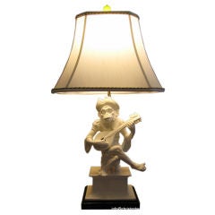 An Italian White Glazed Monkey Lamp