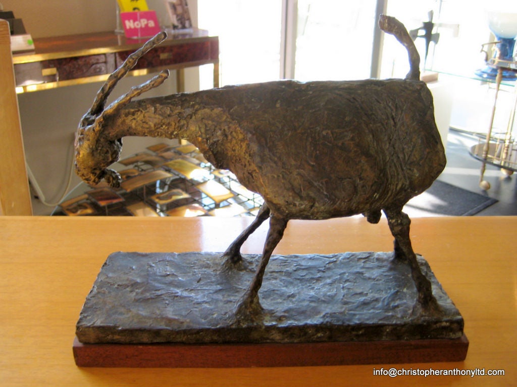 A patinated bronze sculpture of a goat on a wooden base.<br />
Cast by the renowned Modern Art Foundry in New York.This sculpture is signed on the bronze base under the tail with the initials HW and the foundry marks are below the signature.<br