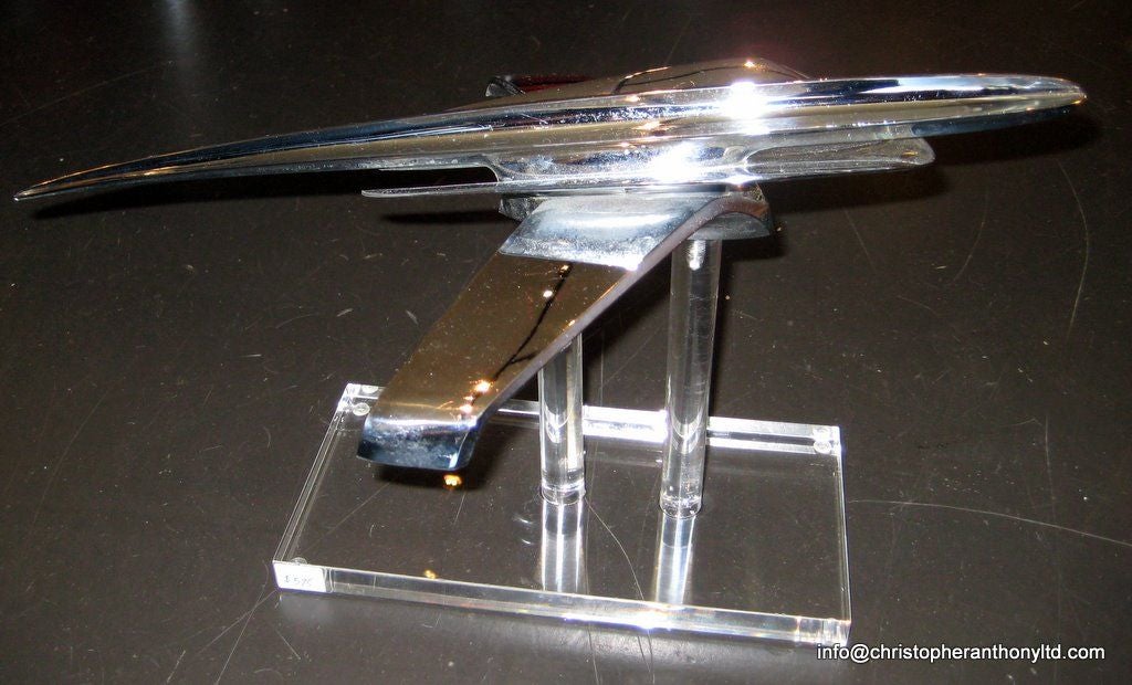 A vintage 1950's Studebaker hood ornament newly mounted on a wonderful custom Lucite display stand. This is certainly one of the most supersonic and aerodynamic hood ornament designs to ever have been produced.