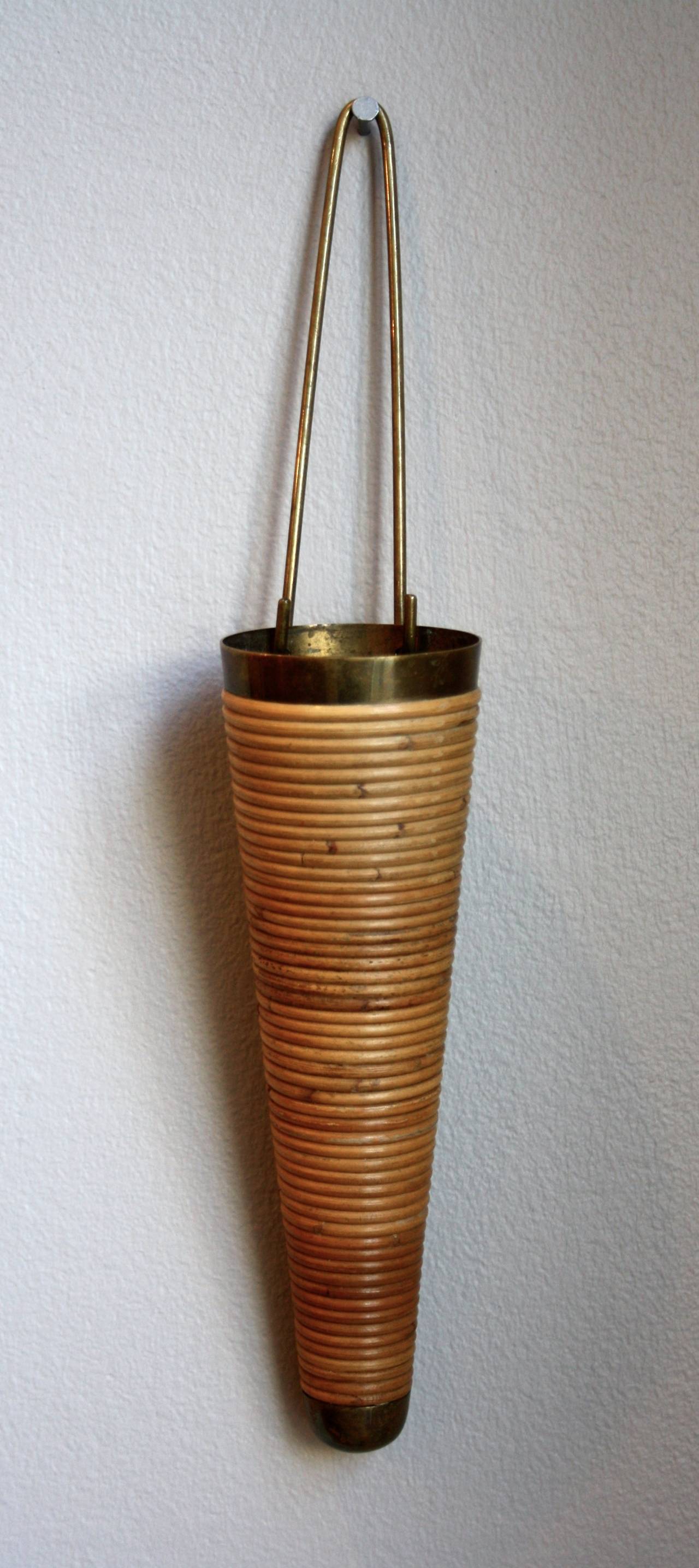Very rare brass and wicker piece by Carl Auböck. Beautiful wall-mounted vase in great condition with the original wicker intact.