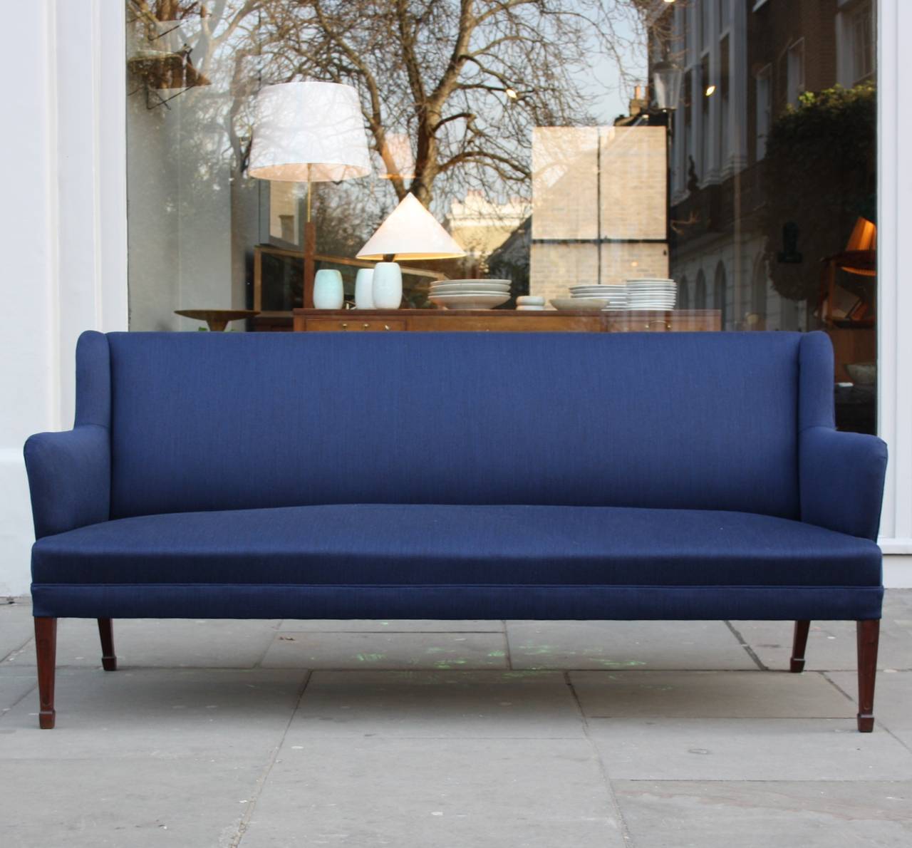 Elegant sofa designed and made by Fritz Henningsen. 
Wool navy upholstery and carved mahogany legs as a token of the this exceptional quality.