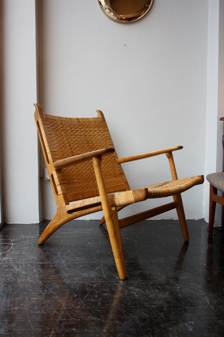 Pair of great CH27 armchairs by Hans Wegner in solid oak and wicker. Made by Carl Hansen in the 1950s. Rare to see a pair in this condition.