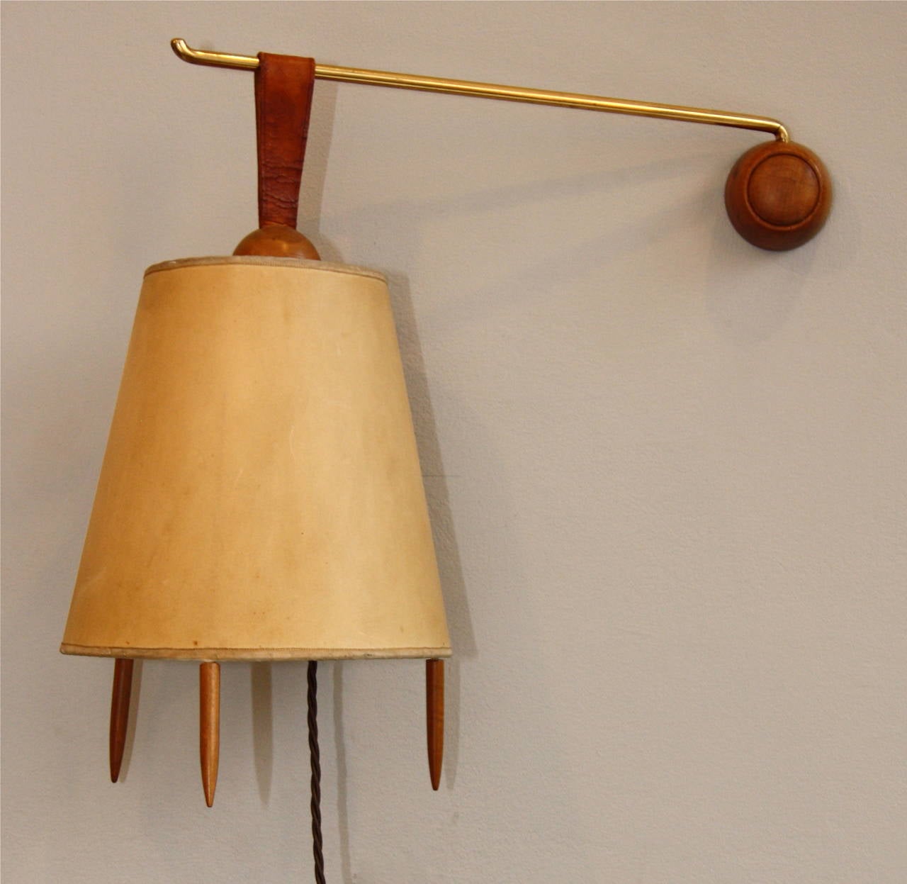 Austrian designed and made by Kalmar, the brass and wood arm allows the light to work as a wall light as well as a table light. Original shade.