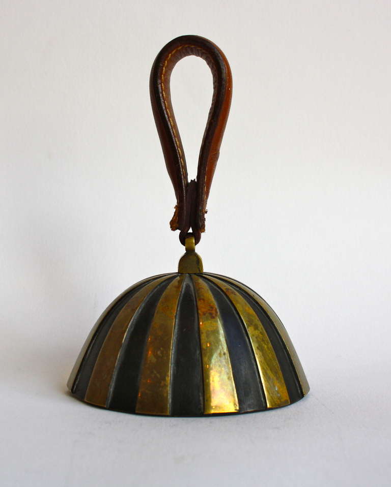 The ultimate dinner bell in heavy cast brass , part patinated and part polished brass and with the original leather handle.