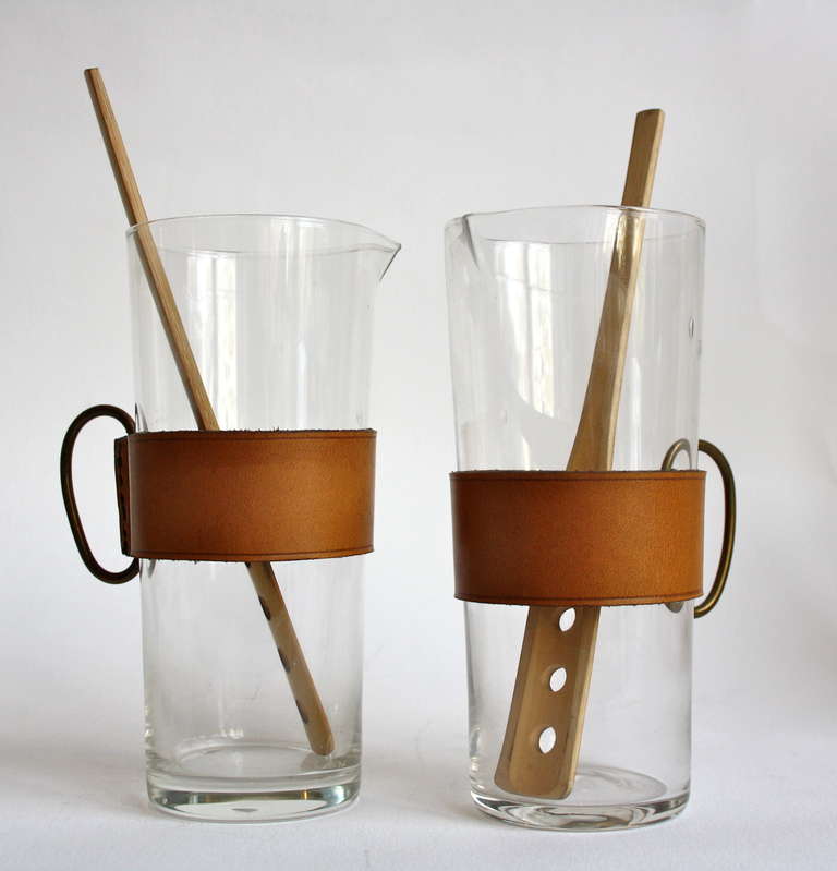 Two individual mouth blown Martini stirrers with cognac leather belts and brass handles. Stirrers made of Bamboo.
