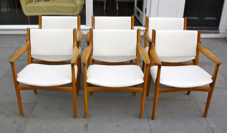 Six large armchairs from Wegners early collaboration with master cabinetmaker Johannes Hansen. Oak frames and new upholstery. Classic Wegner shape executed in great quality , lovely patina to the wood.